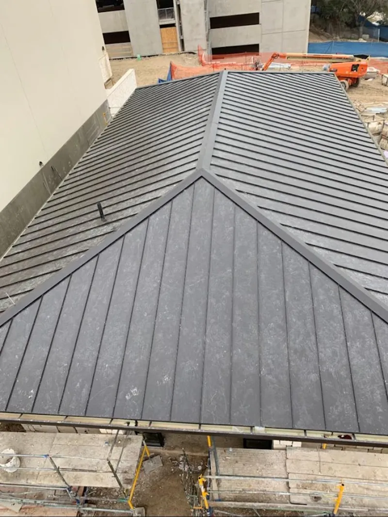 Commercial metal roof construction with crane equipment in Everett